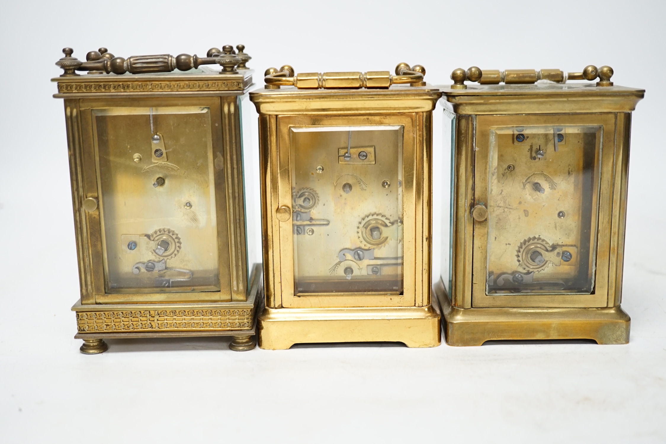 Three carriage timepieces with enamel dials, largest 14.5cm high. Condition - poor to fair